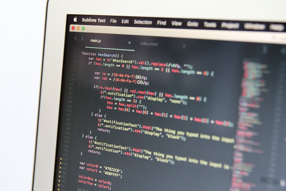 A close-up view of a computer screen displaying JavaScript code with syntax highlighting in various colors, including red, blue, and yellow, on a dark background. The code features functions, variable